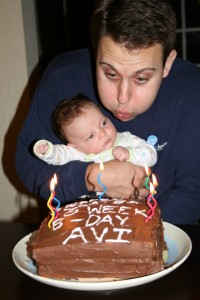 Avi blows out the candles with some help from Uncle Dave